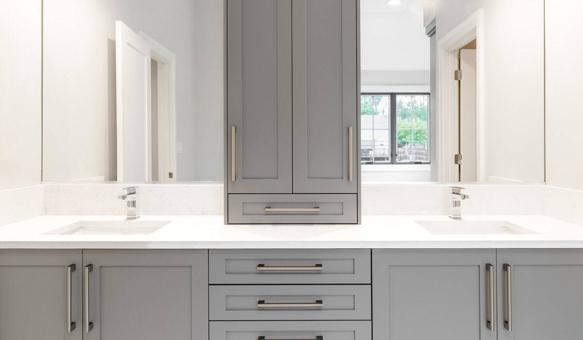 A grey vanity in a large bathroom.