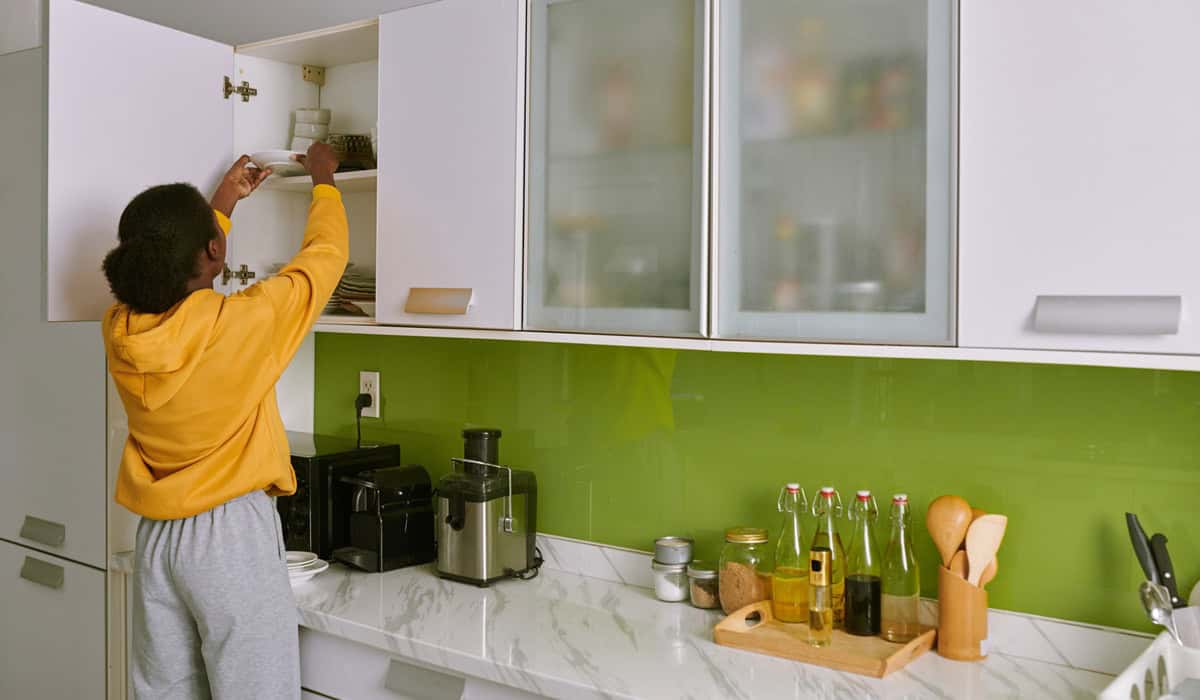 Woman Taking Plate out of Cabinet